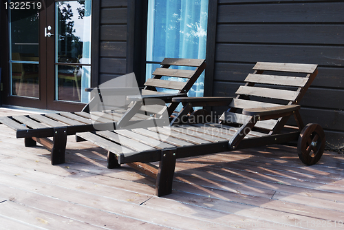 Image of two wooden deck chairs on the terrace 