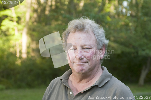 Image of middle age senior man in suburban backyard