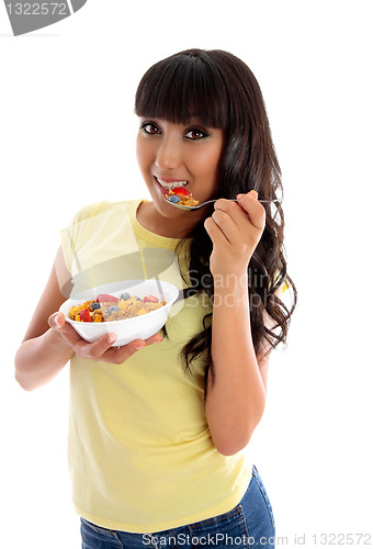 Image of Smiling woman eating cereal breakfast