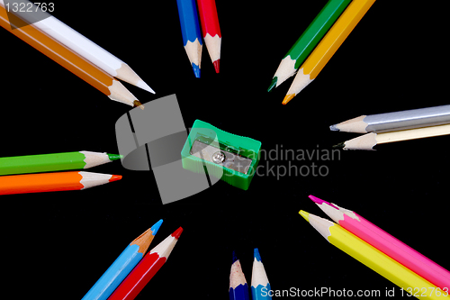 Image of Assortment of coloured pencils with shadow on white/back backgro