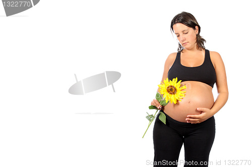 Image of pregnant woman with beautiful belly and sunflower