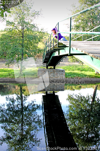 Image of  beautiful woman in an autumn park 