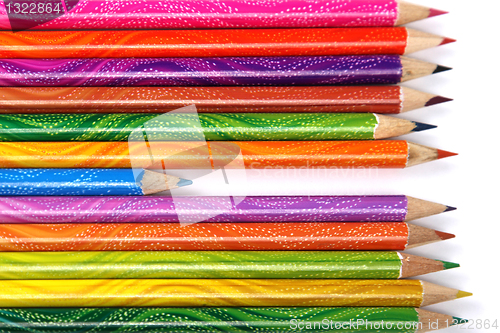 Image of Assortment of coloured pencils with shadow on white background