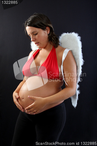 Image of Beautiful pregnant girl with innocent angel wings