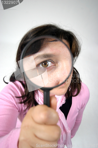 Image of Young businesswoman holding Magnifying Glass, business photo