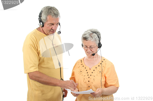 Image of mature couple in a business call center