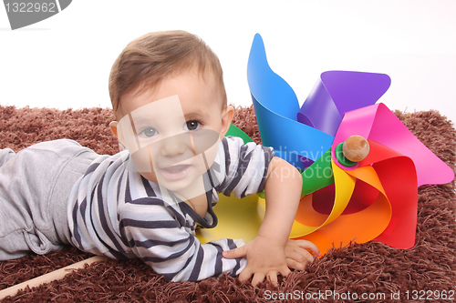 Image of beautiful and happy baby with wind mill