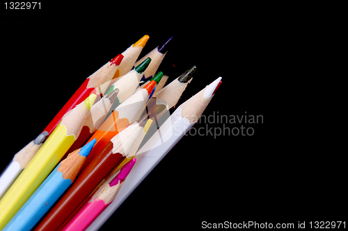 Image of Assortment of coloured pencils with shadow on white/back backgro