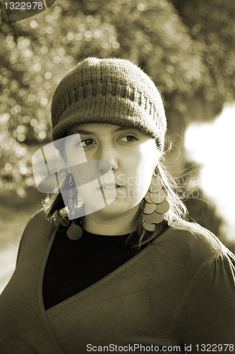 Image of  beautiful woman in an autumn park 