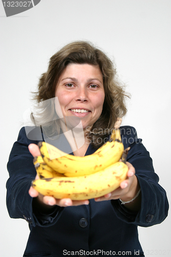 Image of beautiful woman eating banana, healthy food