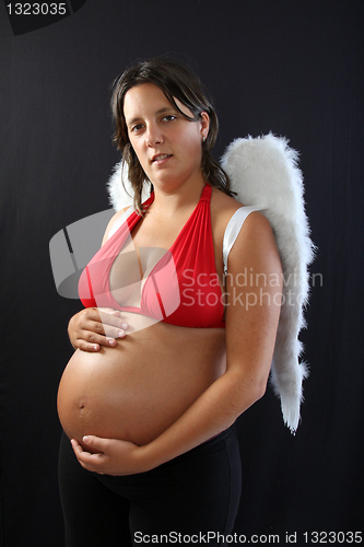 Image of Beautiful pregnant girl with innocent angel wings