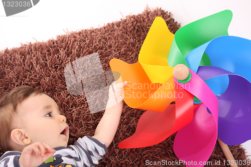 Image of beautiful and happy baby with wind mill