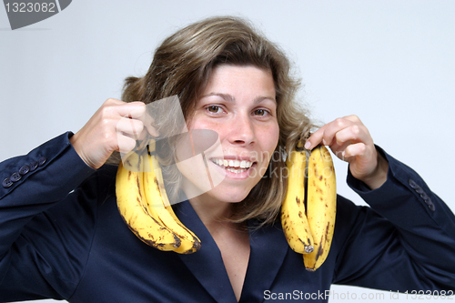 Image of beautiful woman eating banana, healthy food