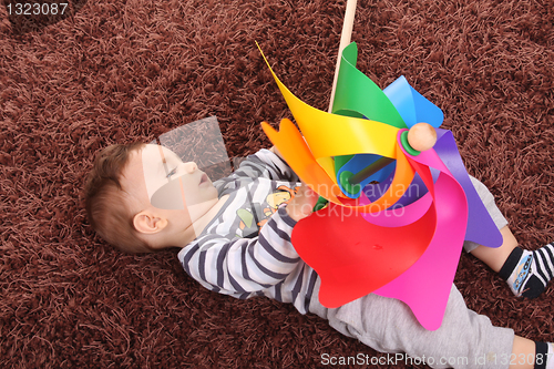 Image of beautiful and happy baby with wind mill