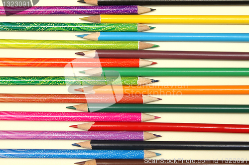 Image of Assortment of coloured pencils with shadow on white background