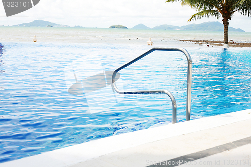 Image of swimming pool with stair at hotel close up