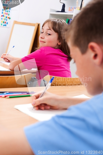 Image of Schoolgirl looking at colleague's test