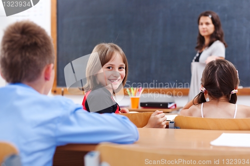 Image of Cheerful schoolgirl in class room