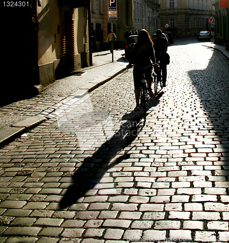 Image of people riding  by bycicle