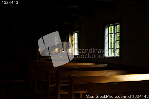 Image of Gloomy rooms of church lighted by windows