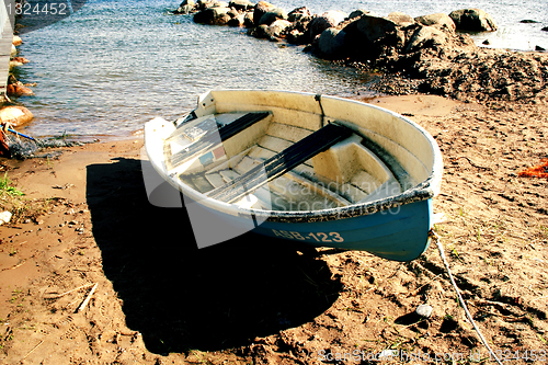 Image of Boat on sandy beach at sunny day