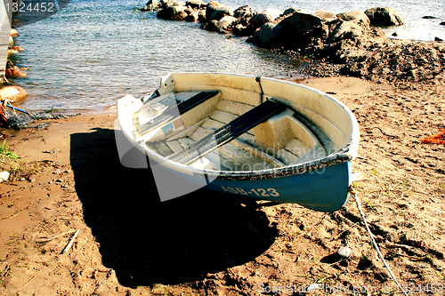 Image of Boat on sandy beach at sunny day