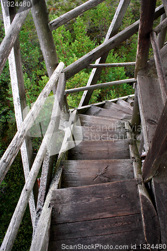 Image of Wheathered wood stairs leading till the ground