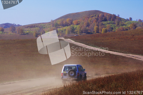 Image of Off-road vehicle running in the grassland