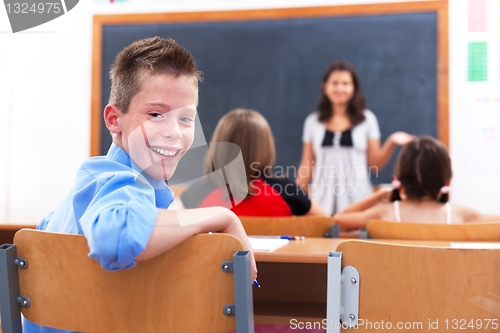 Image of Cheerful boy in class room