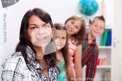 Image of Cheerful teacher and several students