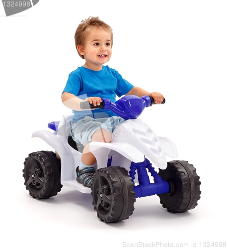 Image of Little boy on toy car