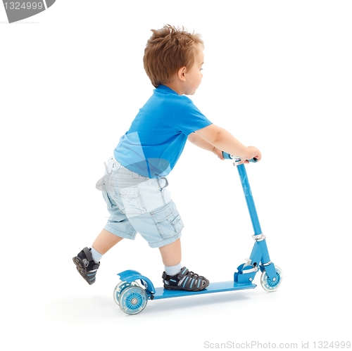 Image of Little boy going with scooter