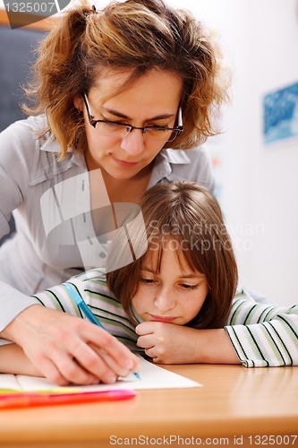 Image of Teacher holding student's hand