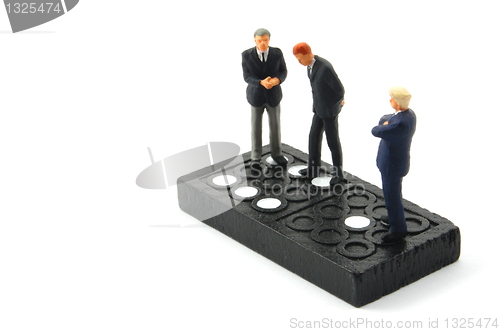 Image of business man on domino isolated