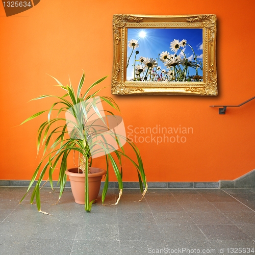 Image of picture on a wall and plant