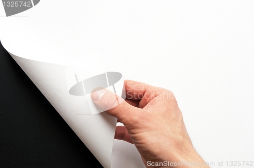 Image of hand turning paper