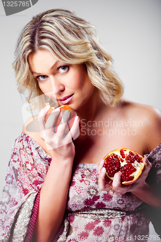 Image of blonde woman with pomegranate