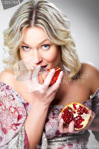 Image of blonde woman with pomegranate