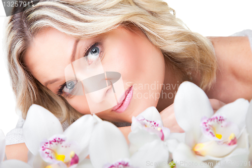 Image of blonde woman with orchid