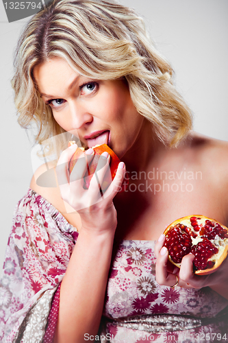 Image of blonde woman with pomegranate