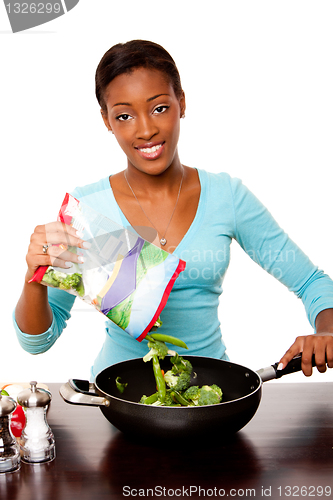 Image of Health conscious woman preparing vegetables