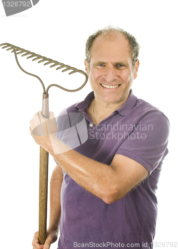 Image of middle age senior man holding garden bow rake tool