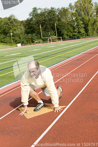 Image of middle age senior man exercising running on sports field and run