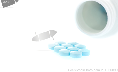 Image of medication spilling from an open bottle