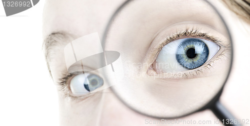 Image of Eye looking thorough magnifying glass