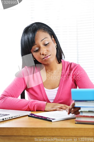 Image of Unhappy female student studying