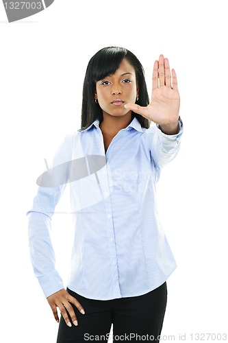 Image of Serious young woman giving stop gesture