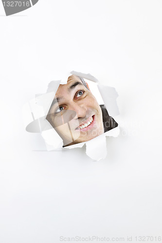 Image of Face looking up through hole in paper
