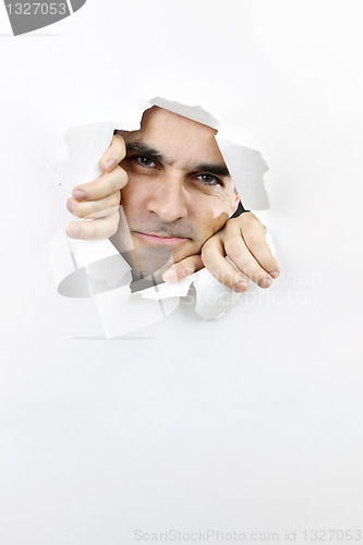 Image of Face looking through hole in paper