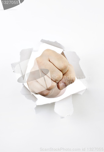 Image of Fist punching through hole in paper